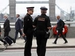 Commuters travel past City of London police officers standing on London Bridge. (Reuters File Photo/Used only for representation)