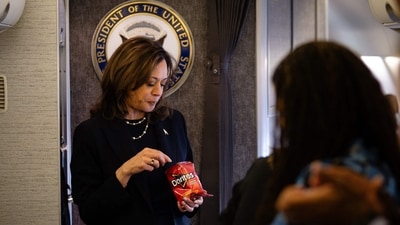 US Vice President and Democratic presidential nominee Kamala Harris eats Doritos and thanks senior staff aboard Air Force Two in Philadelphia, Pennsylvania, on October 27, 2024. (Photo by Erin SCHAFF / POOL / AFP) (AFP)