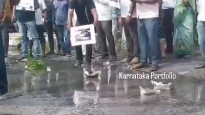 As a mark of protest against the bad roads, the residents prepared paper boats and floated them on water-logged potholes in Bengaluru. (X/Karnataka portfolio) As a mark of protest against the bad roads, the residents prepared paper boats and floated them on water-logged potholes in Bengaluru. (X/Karnataka portfolio)