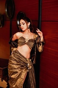 The actor cuts a visually arresting figure in a bronze bralette paired alongside a pleated skirt with a slit and jacket from Vaishali S The actor cuts a visually arresting figure in a bronze bralette paired alongside a pleated skirt with a slit and jacket from Vaishali S