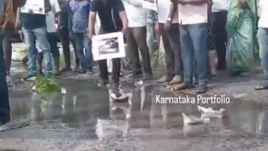 As a mark of protest against the bad roads, the residents prepared paper boats and floated them on water-logged potholes in Bengaluru. (X/Karnataka portfolio)