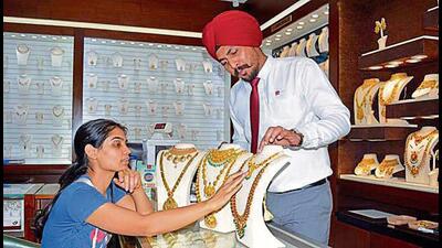 A woman looks at jewellery at a store in Ludhiana (Manish/HT)