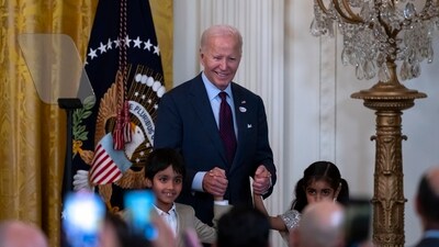 President Joe Biden entered the event holding the hands of Soren on the left and Zara on the right - the children of US congressional representative Ro Khanna. The event was an ode to the achievements of South Asian Americans and their importance to the country's democracy, ahead of the presidential elections. (AP) President Joe Biden entered the event holding the hands of Soren on the left and Zara on the right - the children of US congressional representative Ro Khanna. The event was an ode to the achievements of South Asian Americans and their importance to the country's democracy, ahead of the presidential elections. (AP)