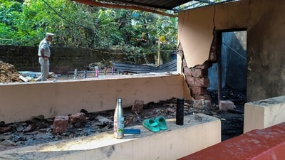 A police officer scans the scene where an explosion occurred Monday night when a fireworks storage facility caught fire injuring several people during a festival at Veerarkavu Hindu temple, at Neeleswaram in Kasargod district, Kerala, on Tuesday, (AP) A police officer scans the scene where an explosion occurred Monday night when a fireworks storage facility caught fire injuring several people during a festival at Veerarkavu Hindu temple, at Neeleswaram in Kasargod district, Kerala, on Tuesday, (AP)