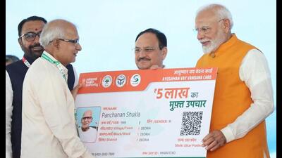 Prime Minister Narendra Modi, along with Union minister of health and family welfare JP Nadda, hands over an ‘Ayushman card’ to a beneficiary during an event, at All India Institute of Ayurveda (AIIA) in New Delhi on Tuesday. (HT Photo) Prime Minister Narendra Modi, along with Union minister of health and family welfare JP Nadda, hands over an ‘Ayushman card’ to a beneficiary during an event, at All India Institute of Ayurveda (AIIA) in New Delhi on Tuesday. (HT Photo)