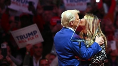 Former US President and Republican presidential candidate Donald Trump kisses former First Lady Melania Trump on stage during a campaign at Madison Square Garden in New York, October 27, 2024. (Photo by ANGELA WEISS / AFP) (AFP)