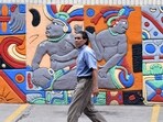 A man walks past a mural decorated with Mayan characters at Morazan Boulevard in Tegucigalpa on October 29, 2024. A man walks past a mural decorated with Mayan characters at Morazan Boulevard in Tegucigalpa on October 29, 2024.