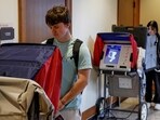 Students cast their ballots as they take advantage of early voting in the 2024 election at a the University of Wisconsin.
