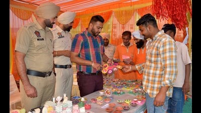 Central jail employees during the exhibition showcasing goods made by inmates outside the prison in Ludhiana on Wednesday. (Manish/HT)