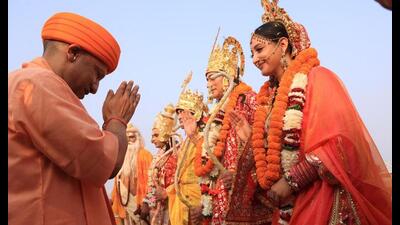 Chief minister Yogi Adityanath welcomes artistes playing Lord Ram, Lakshman and Sita after receiving them from ‘Pushpak Vimaan’ (helicopter) on the banks of Saryu in Ayodhya on Wednesday (Deepak Gupta/HT Photo) Chief minister Yogi Adityanath welcomes artistes playing Lord Ram, Lakshman and Sita after receiving them from ‘Pushpak Vimaan’ (helicopter) on the banks of Saryu in Ayodhya on Wednesday (Deepak Gupta/HT Photo)