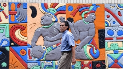 A man walks past a mural decorated with Mayan characters at Morazan Boulevard in Tegucigalpa on October 29, 2024. (AFP) A man walks past a mural decorated with Mayan characters at Morazan Boulevard in Tegucigalpa on October 29, 2024. (AFP)