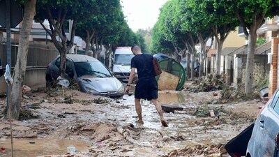 A man walks in a street covered in mud in a flooded area in Picanya, near Valencia. (AFP) A man walks in a street covered in mud in a flooded area in Picanya, near Valencia. (AFP)