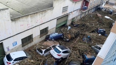 A picture taken in Picanya, near Valencia, eastern Spain shows cars piled in a stree after floods. (AFP) A picture taken in Picanya, near Valencia, eastern Spain shows cars piled in a stree after floods. (AFP)