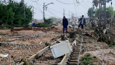 Residents walk among debris on a rail track following flood in Picanya. Floods triggered by torrential rains in Spain's eastern Valencia region has left 51 people dead. (AFP) Residents walk among debris on a rail track following flood in Picanya. Floods triggered by torrential rains in Spain's eastern Valencia region has left 51 people dead. (AFP)
