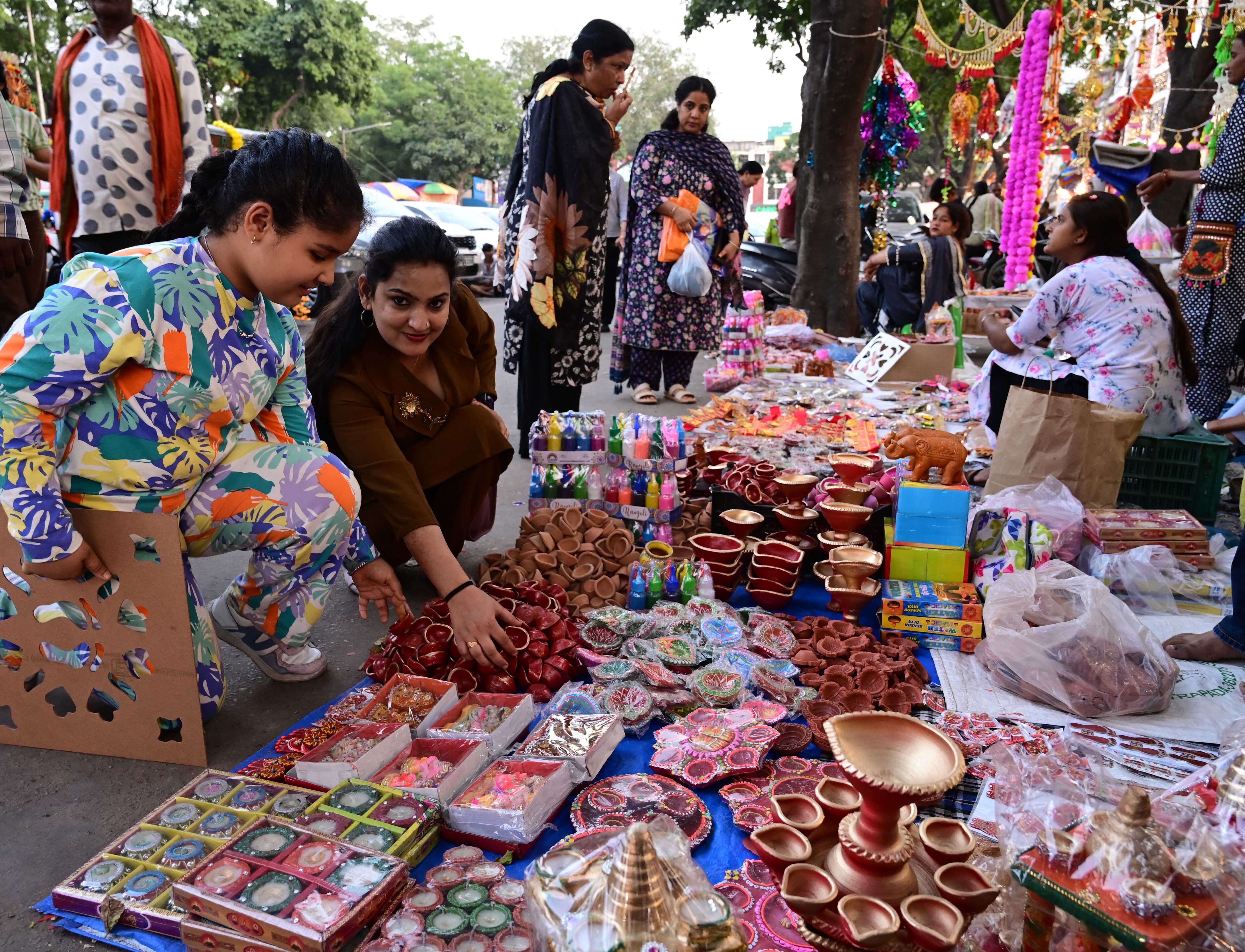 Shoppers checking out decorative items for Diwali at the Sector-19 market in Chandigarh. (Keshav Singh/HT) Shoppers checking out decorative items for Diwali at the Sector-19 market in Chandigarh. (Keshav Singh/HT)