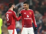 Manchester United's Portuguese midfielder #08 Bruno Fernandes (L) celebrates with Manchester United's Brazilian midfielder #18 Casemiro