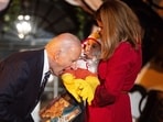 TOPSHOT - US President Joe Biden jokingly bites a baby dressed as a chicken as he hosts a Halloween trick-or-treat event at the South Portico of the White House in Washington, DC, on October 30, 2024. (Photo by Tierney CROSS / AFP)