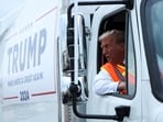 Republican presidential nominee and former U.S. President Donald Trump sits inside garbage truck, in Green Bay, Wisconsin, U.S., October 30, 2024. REUTERS/Brendan McDermid