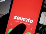 The logo of Indian food delivery company Zomato is seen on its app on a mobile phone displayed in front of its company website in this illustration picture taken July 14, 2021.