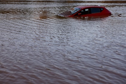 A car lies partially submerged after floods in Utiel, Spain, October 30, 2024. (Reuters)