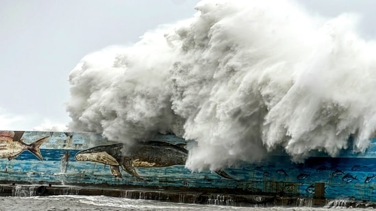 This picture taken and released by Taiwan's Central News Agency (CNA) on October 31, 2024 shows a wave crashing over a sea wall as Super Typhoon Kong-rey neared the coast in Taitung. Fierce winds and torrential rain lashed Taiwan on October 31 as Super Typhoon Kong-rey neared, forcing thousands to flee from one of the most powerful storms to threaten the island in years. Taiwan shuts down as Super Typhoon Kong-Rey nears: Stock market, schools, flights on hold (Photo by CNA / AFP)