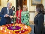 US President Joe Biden lights a lamp as First Lady Jill Biden and Vice-President Kamala Harris look on during an event to celebrate Diwali at the White House in Washington on Monday. (PTI) US President Joe Biden lights a lamp as First Lady Jill Biden and Vice-President Kamala Harris look on during an event to celebrate Diwali at the White House in Washington on Monday. (PTI)