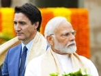 Canada's Prime Minister Justin Trudeau, left, walks past India's Prime Minister Narendra Modi as they take part in a wreath-laying ceremony at Raj Ghat, Mahatma Gandhi's cremation site, during the G20 Summit in New Delhi, on September 10, 2023 (AP)