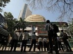 Muhurat Trading 2024 LIVE updates: People look at a screen displaying the Sensex results on the facade of the Bombay Stock Exchange (BSE) building in Mumbai.