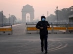 A man wears a face mask as he jogs in the early morning smog, the day after Diwali, in New Delhi, on Friday, A man wears a face mask as he jogs in the early morning smog, the day after Diwali, in New Delhi, on Friday,