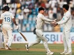 New Zealand's Rachin Ravindra and Glenn Phillips celebrate the wicket of India's Virat Kohli. New Zealand's Rachin Ravindra and Glenn Phillips celebrate the wicket of India's Virat Kohli.