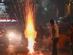 People burst firecrackers during Diwali festivities at Patel Nagar in New Delhi on Thursday. (Sanchit Khanna/HT Photo)