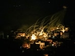 A picture taken from the area of Marjeyoun in southern Lebanon shows explosions over buildings in the town of Khiam, during Israeli bombardment on October 31, 2024, amid the ongoing war between Israel and Hezbollah. 