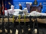 Firearms and illicit drugs seized last week are displayed as Royal Canadian Mounted Police Chief Supt. Stephen Lee, back from left, Asst. Commissioner David Teboul, Insp. Jillian Wellard and Cpl. Arash Seyed leave after a news conference at RCMP headquarters, in Surrey, British Columbia, Firearms and illicit drugs seized last week are displayed as Royal Canadian Mounted Police Chief Supt. Stephen Lee, back from left, Asst. Commissioner David Teboul, Insp. Jillian Wellard and Cpl. Arash Seyed leave after a news conference at RCMP headquarters, in Surrey, British Columbia,