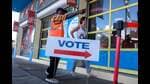 MIAMI, FLORIDA - OCTOBER 21: A poll worker directs a voter to a polling station set up inside of the Little Haiti Cultural Complex as Early Voting begins on October 21, 2024, in Miami, Florida. Early voting runs from Oct. 21 through Nov. 3 in Miami-Dade and Broward. People head to the polls to decide, among other races, the next president of the United States. Joe Raedle/Getty Images/AFP (Photo by JOE RAEDLE / GETTY IMAGES NORTH AMERICA / Getty Images via AFP) (Getty Images via AFP)