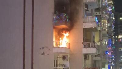 A massive fire broke out on the 17th floor of a high-rise in Supertech Eco Village 1 in Greater Noida West, around 10.30pm after a firecracker landed on an outdoor unit of an AC in the flat balcony. (HT Photo) A massive fire broke out on the 17th floor of a high-rise in Supertech Eco Village 1 in Greater Noida West, around 10.30pm after a firecracker landed on an outdoor unit of an AC in the flat balcony. (HT Photo)