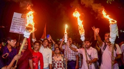 Junior doctors raise slogans during a torch rally towards the CBI office in protest against the alleged rape and murder of a woman medic at the RG Kar Medical College and Hospital, in Kolkata on Oct. 30, 2024. (PTI)