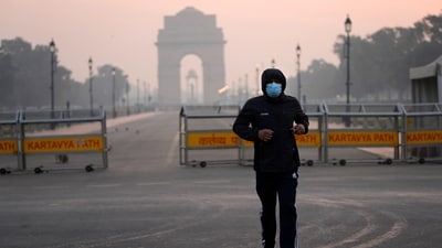 A man wears a face mask as he jogs in the early morning smog, the day after Diwali, in New Delhi, on Friday, (AP) A man wears a face mask as he jogs in the early morning smog, the day after Diwali, in New Delhi, on Friday, (AP)
