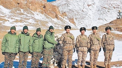 Indian and Chinese army soldiers exchange sweets along the Line of Actual Control (LAC) near Karakoram pass in Ladakh on Thursday. (AFP) Indian and Chinese army soldiers exchange sweets along the Line of Actual Control (LAC) near Karakoram pass in Ladakh on Thursday. (AFP)