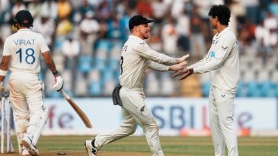 New Zealand's Rachin Ravindra and Glenn Phillips celebrate the wicket of India's Virat Kohli. (PTI)