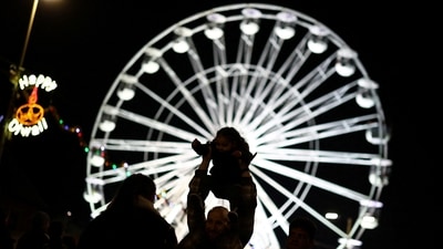 People take photos on the Golden Mile during Diwali celebrations in Leicester,&nbsp; (REUTERS)