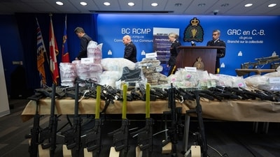 Firearms and illicit drugs seized last week are displayed as Royal Canadian Mounted Police Chief Supt. Stephen Lee, back from left, Asst. Commissioner David Teboul, Insp. Jillian Wellard and Cpl. Arash Seyed leave after a news conference at RCMP headquarters, in Surrey, British Columbia, (AP) Firearms and illicit drugs seized last week are displayed as Royal Canadian Mounted Police Chief Supt. Stephen Lee, back from left, Asst. Commissioner David Teboul, Insp. Jillian Wellard and Cpl. Arash Seyed leave after a news conference at RCMP headquarters, in Surrey, British Columbia, (AP)