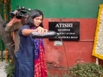 Rajya Sabha MP Swati Maliwal pours dirty water, allegedly brought from the house of an army officer in Dwarka, outside Delhi Chief Minister Atishi's residence, in New Delhi. Rajya Sabha MP Swati Maliwal pours dirty water, allegedly brought from the house of an army officer in Dwarka, outside Delhi Chief Minister Atishi's residence, in New Delhi.