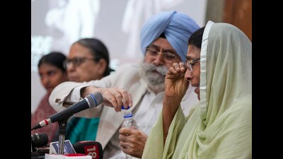 A victim of the 1984 anti-Sikh riots with advocate Harvinder Singh Phoolka during a press conference, in New Delhi on Saturday. (PTI)