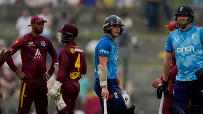 England's Jamie Overton, right, and Sam Curran look at the scoreboard. AP/PTI(AP11_01_2024_000157A) (AP) England's Jamie Overton, right, and Sam Curran look at the scoreboard. AP/PTI(AP11_01_2024_000157A) (AP)