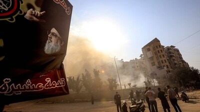 A poster of slain Hezbollah leader Hasan Nasrallah hangs near the smouldering rubble of a building in the aftermath of overnight Israeli airstrikes that targeted the neighbourhood of Kafaat in Beirut's southern suburbs on November 1, 2024. (Photo by AFP) (AFP)