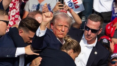 Republican candidate Donald Trump is seen with blood on his face surrounded by secret service agents as he is taken off the stage at a campaign event at Butler Farm Show Inc. in Butler, Pennsylvania, on July 13. (AFP)
