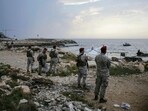 Lebanese soldies inspect the beach at a reported landing site for a "naval commando force" which abducted a Lebanese mariner according to a military source, in the northern coastal town of Batroun on November 2, 2024. Lebanese soldies inspect the beach at a reported landing site for a "naval commando force" which abducted a Lebanese mariner according to a military source, in the northern coastal town of Batroun on November 2, 2024.