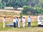 Police and forest officials examine the site where an elephant was found dead on Wednesday. (PTI) Police and forest officials examine the site where an elephant was found dead on Wednesday. (PTI)