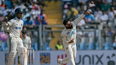 New Zealand's Ajaz Patel bowls as India's Yashasvi Jaiswal (L) looks on during the third day of the third and final Test cricket match between India and New Zealand at the Wankhede Stadium in Mumbai. (AFP) New Zealand's Ajaz Patel bowls as India's Yashasvi Jaiswal (L) looks on during the third day of the third and final Test cricket match between India and New Zealand at the Wankhede Stadium in Mumbai. (AFP)