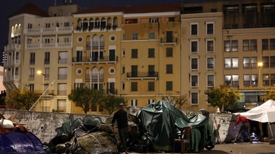 A displaced man walks in front of tent under rain at Beirut's central Martyrs' Square, where many families spend the night fleeing the ongoing Israeli strikes in southern Beirut in Lebanon. (REUTERS)